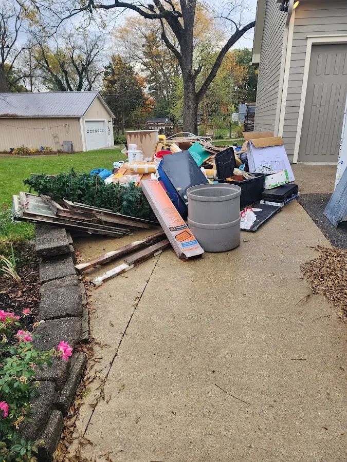 Dumpster being loaded with debris for Roofing Dumpster Rental in Gooding